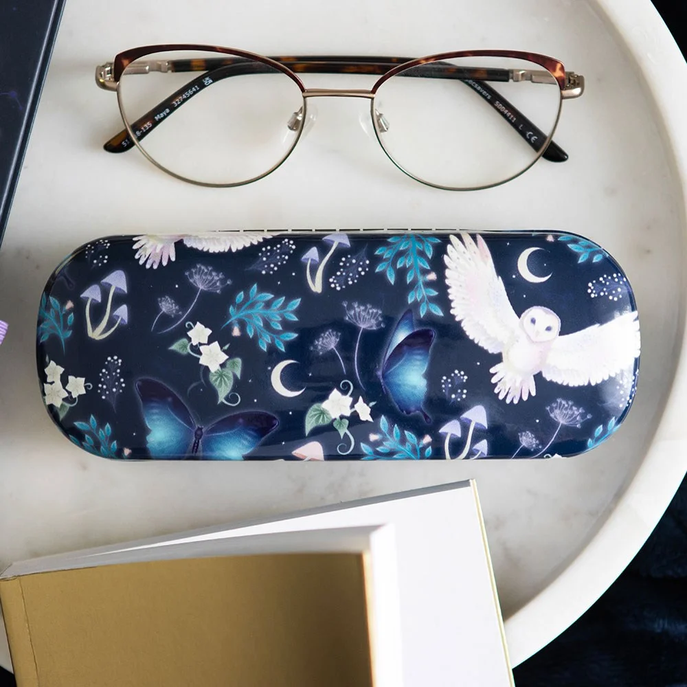 Hard shell glasses case with night flight owl, moth, crescent moon, and forest plant print on dark background