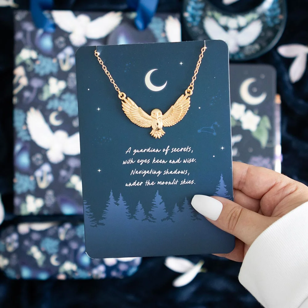 Night owl necklace with gold-tone chain and stainless-steel owl charm on a forest night sky greeting card with gold envelope