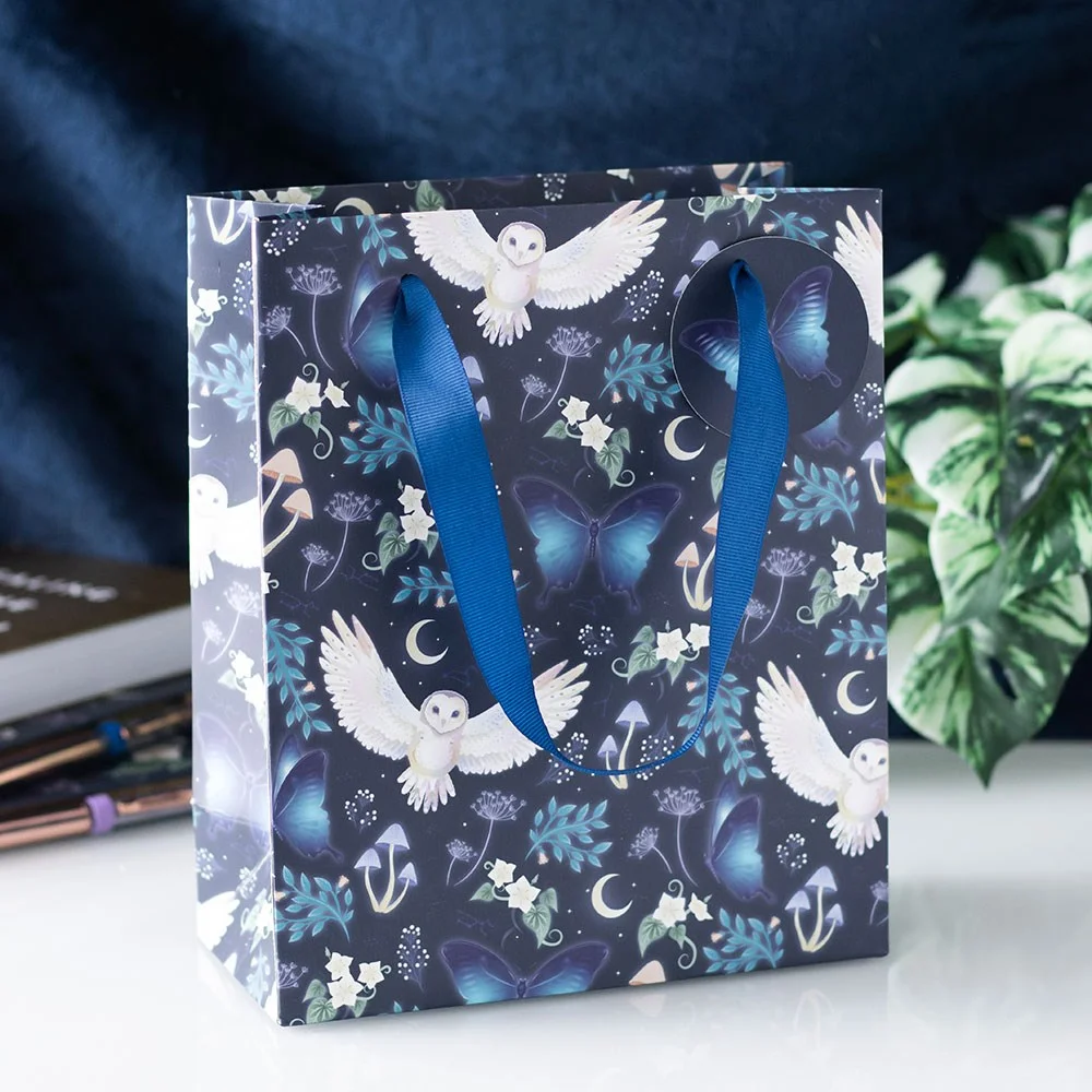 Midnight owl gift bag with flying owls, crescent moons, moths, and forest plants on dark background, 23cm tall