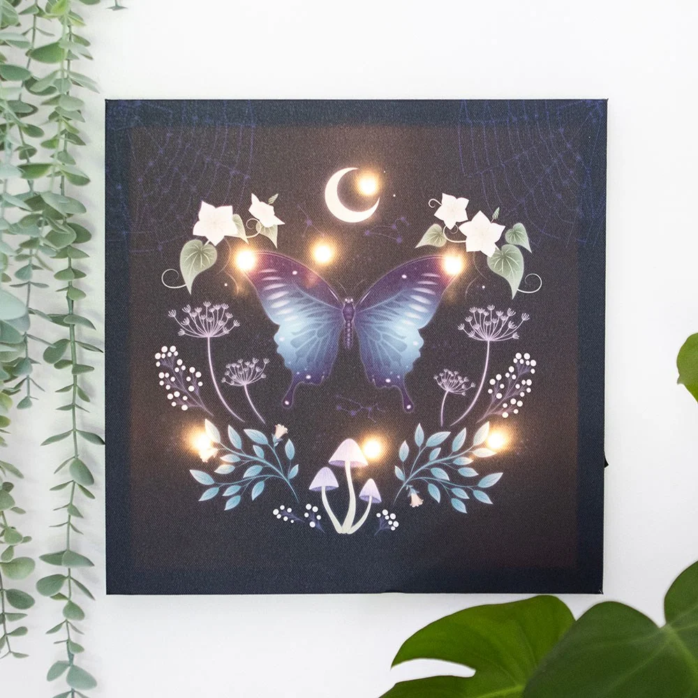 Square light up canvas plaque featuring a glowing mystical moth and plant design on a dark background