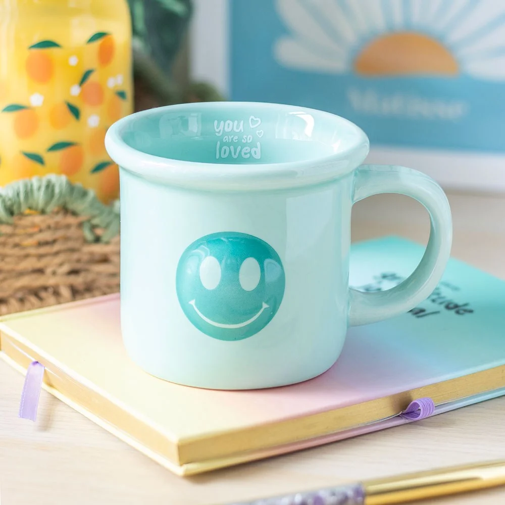 Blue happy face mug with "You are so loved" text on inside rim, 400ml capacity, cheerful design for morning brew
