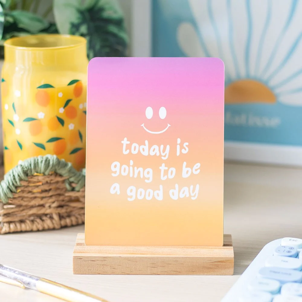 10 brightly coloured affirmation cards set displayed on a wooden stand, ideal for desk or side table