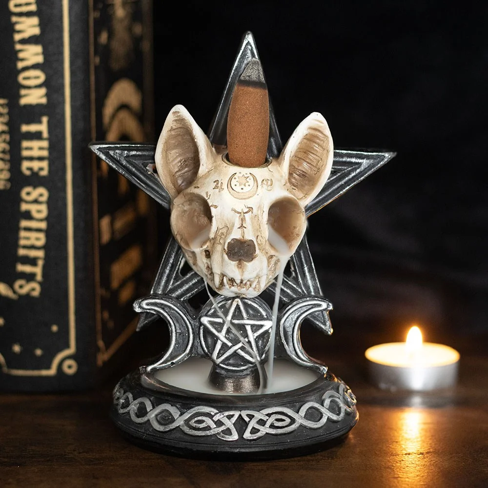 Skeleton cat shaped backflow incense burner with Ouija board details in gothic style, black and white design.