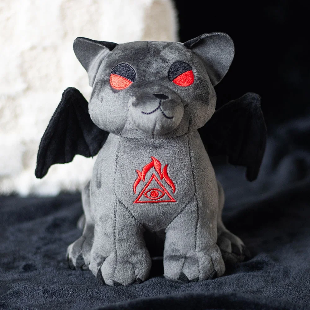 Grey vampire cat plush with black bat wings, red embroidered eyes, and stitched all-seeing eye on chest sitting upright
