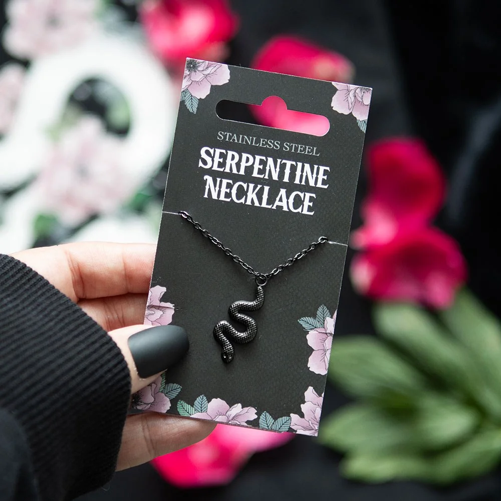 Black snake pendant necklace on floral backing card, nickel-free stainless steel with a sleek dark finish