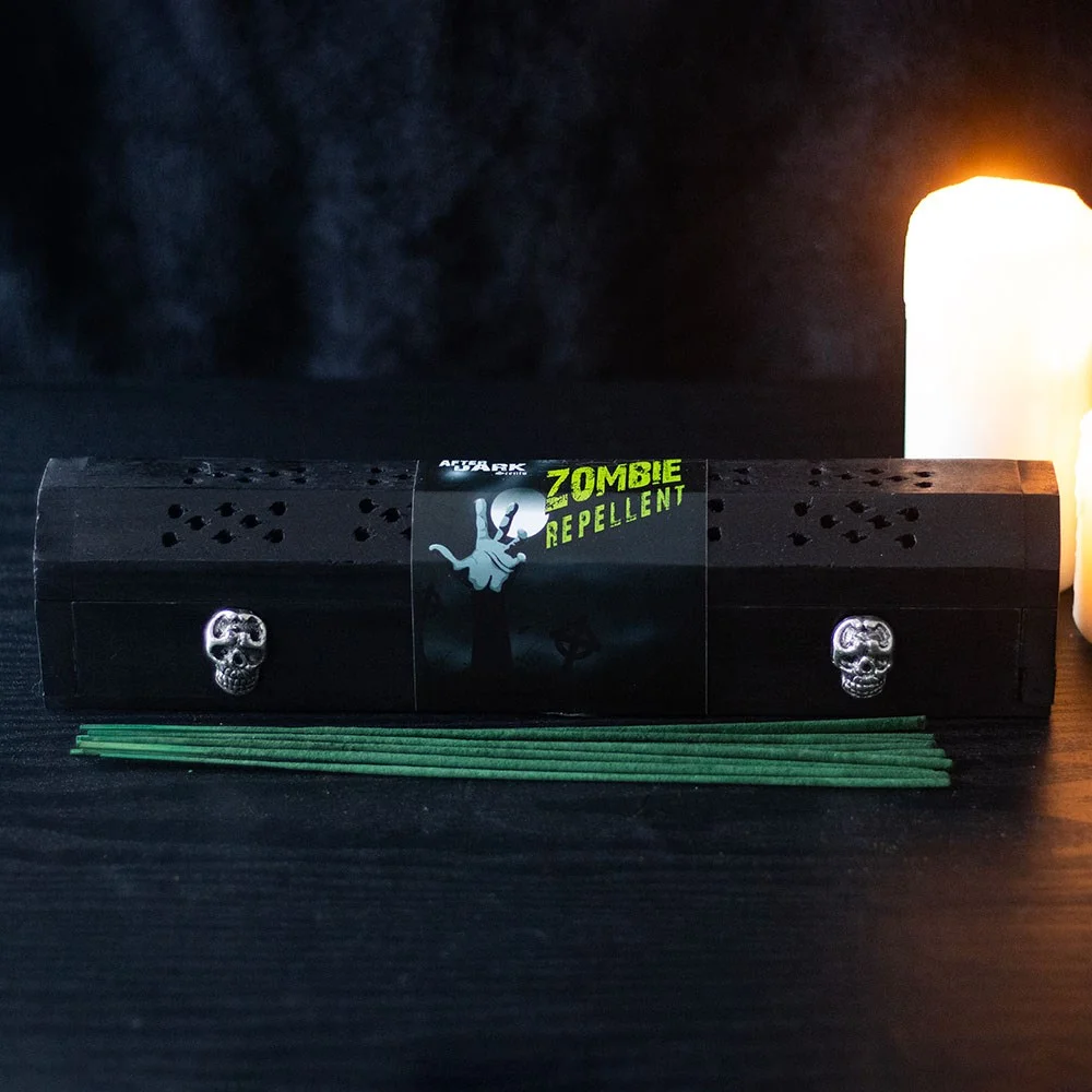 Wooden box with silver skulls holding jasmine-scented zombie repellent incense sticks for warding off undead