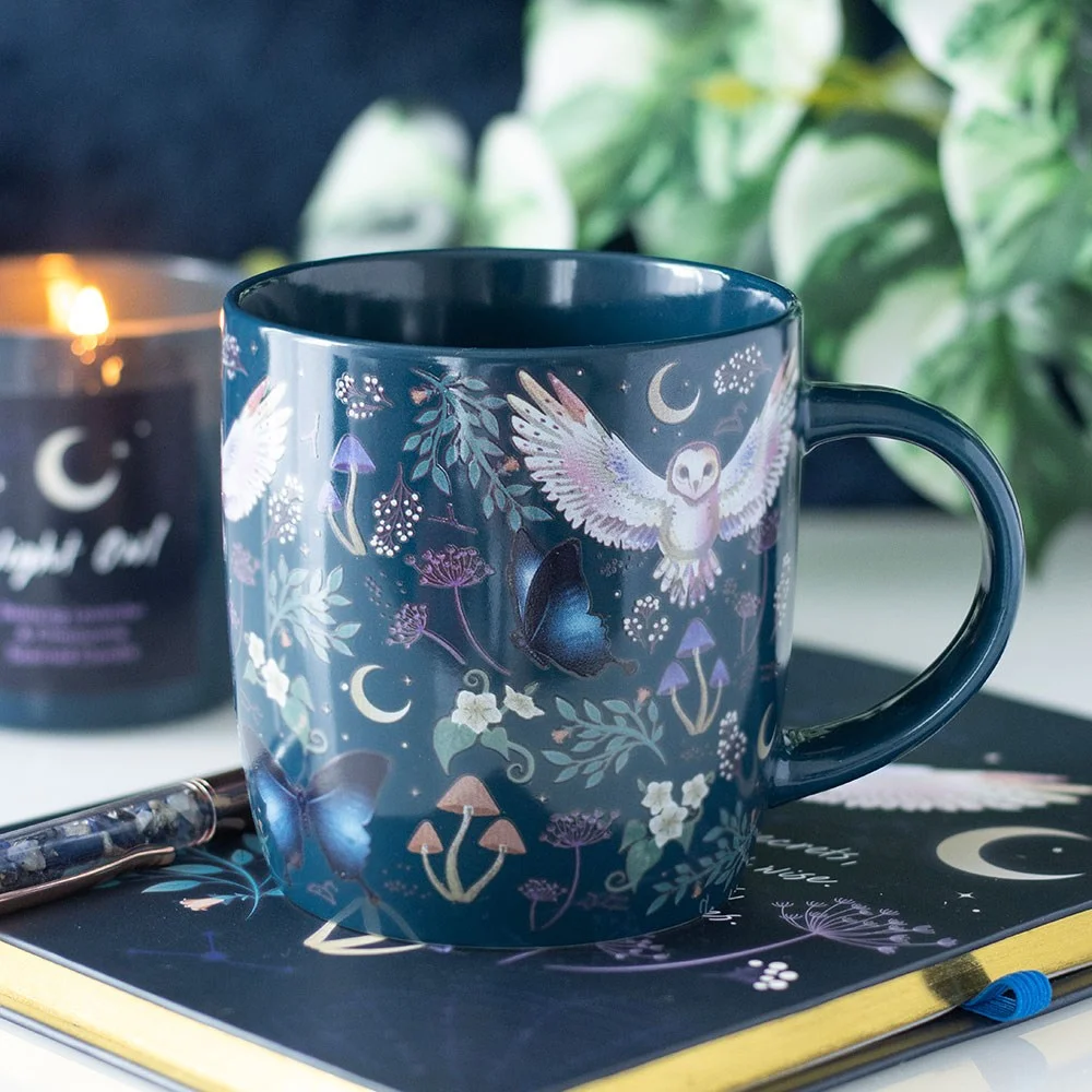 Night flight mug with navy‑blue ceramic cup showing flying night owls, crescent moons, forest plants