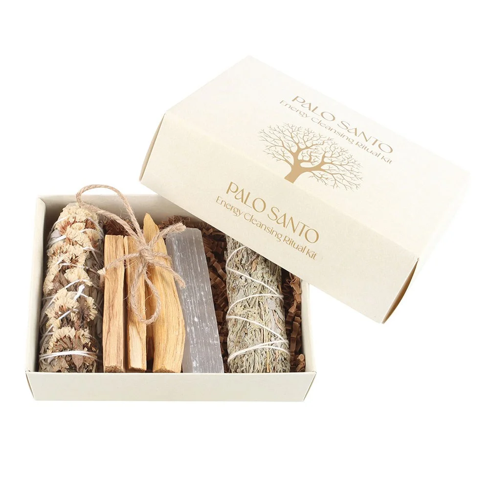 Palo Santo cleansing kit with Palo Santo sticks, two sage bundles, and a selenite crystal on a white background