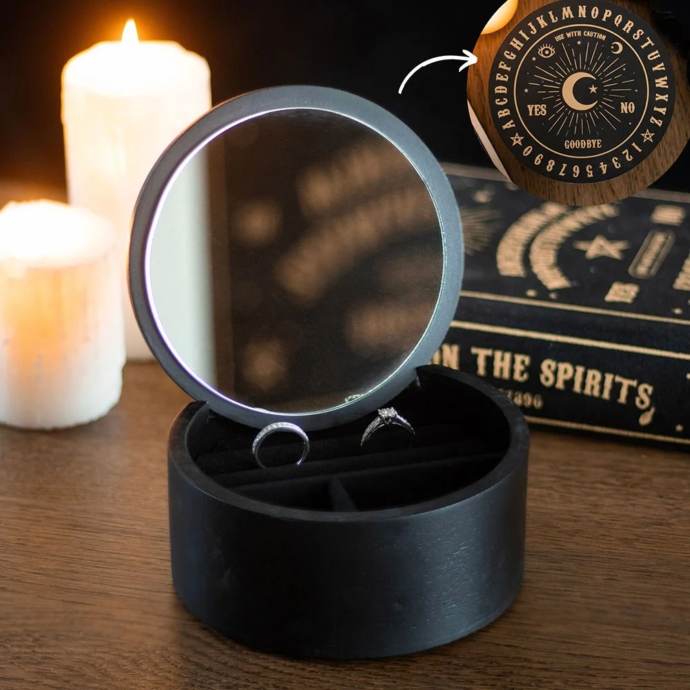 Black talking board jewellery box with gold mystical design, open to show mirror and velvet-lined compartments