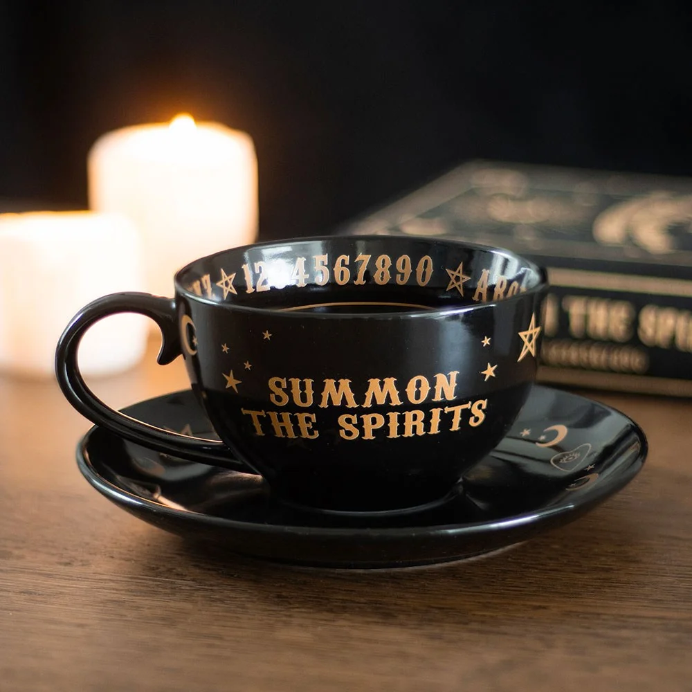 Black talking board teacup with gold accents on matching saucer, ceramic, 500ml capacity, dishwasher and microwave safe