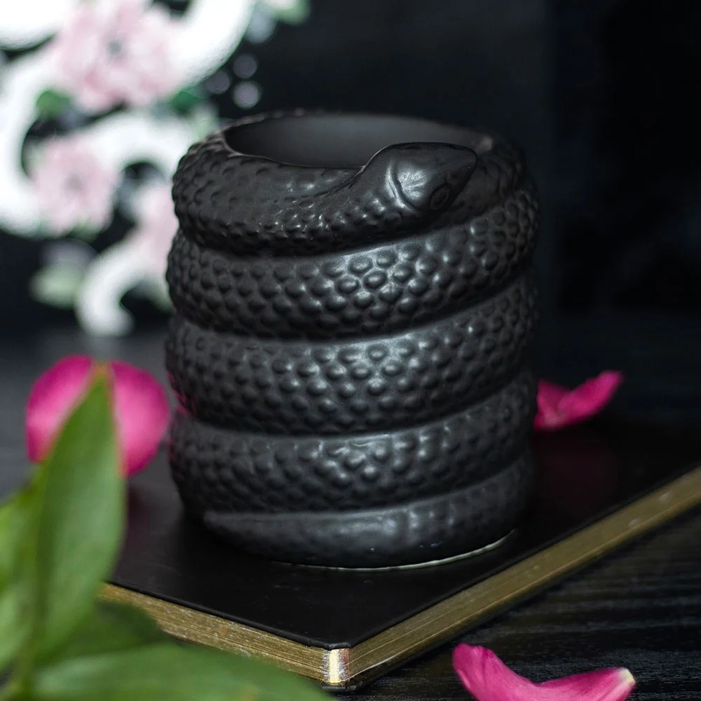 Coiled black snake-shaped oil burner and wax warmer in black, designed for home fragrance use