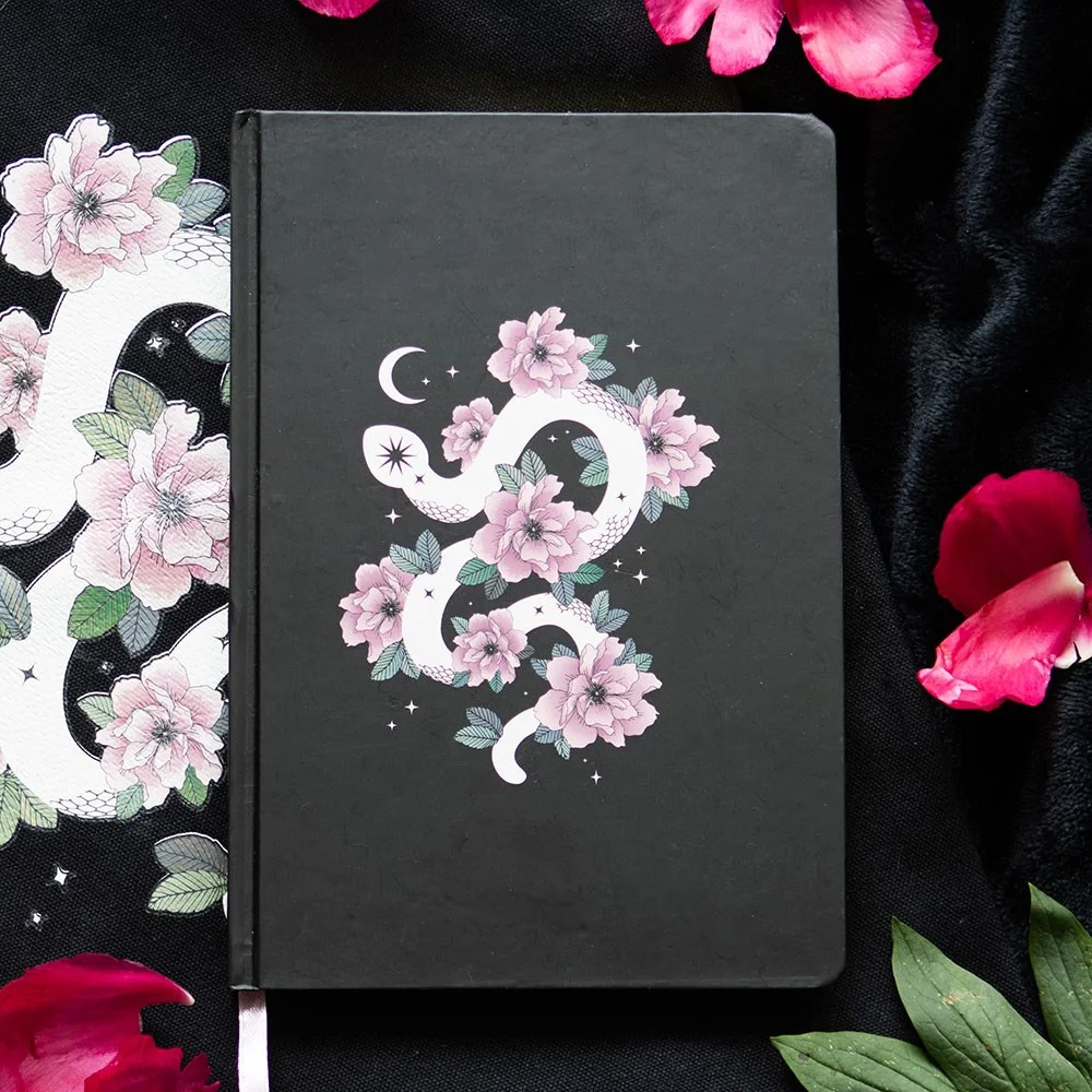 Floral snake notebook with curled white snake and soft pink flower design on A5 lined pages with ribbon marker