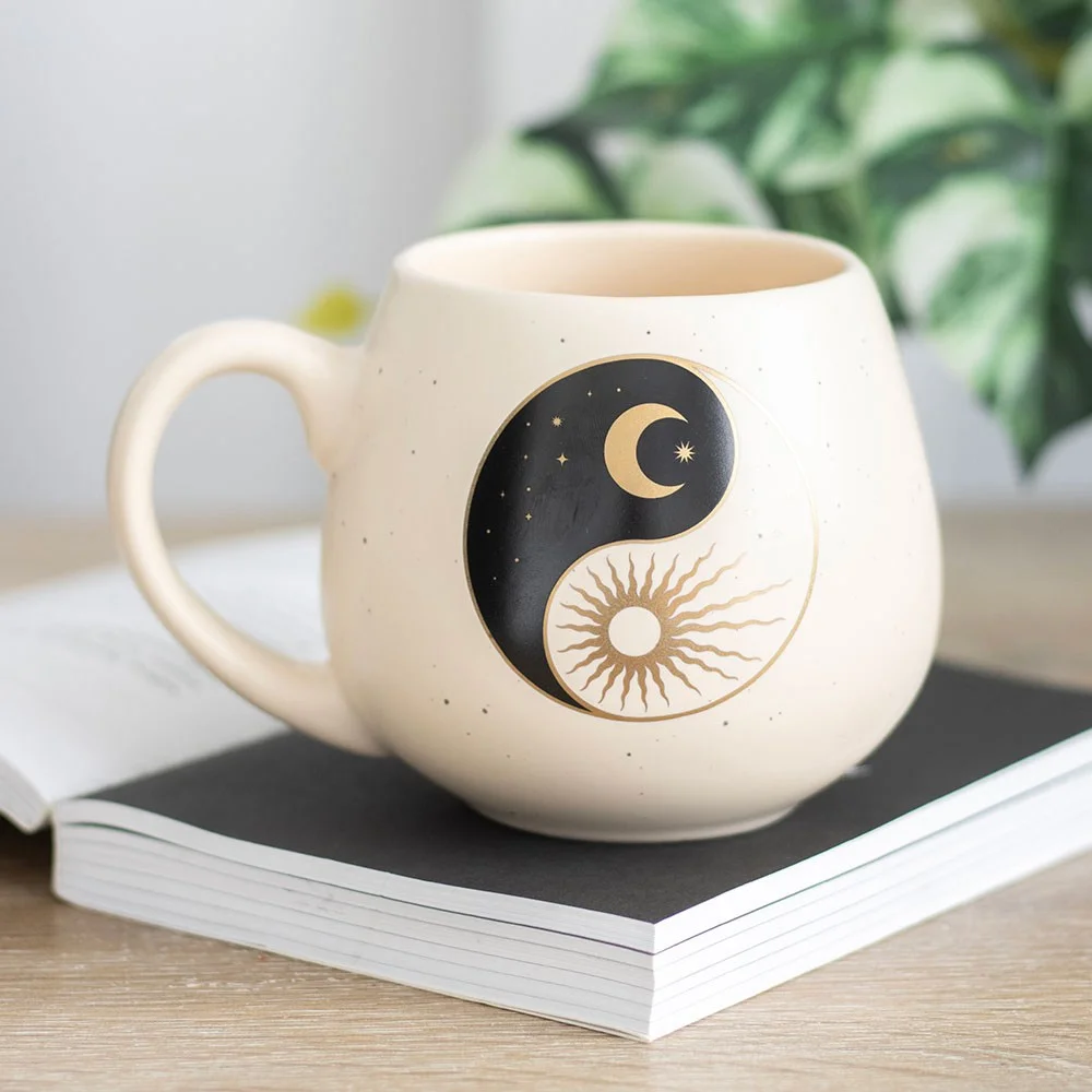 White rounded yin yang mug with sun and crescent moon design, 500ml capacity, on a plain background