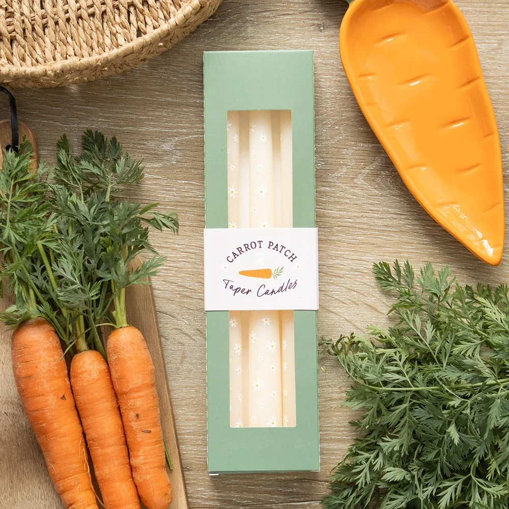 Set of 3 unscented carrot patch daisy taper candles with floral design, ideal for spring home decor and table settings