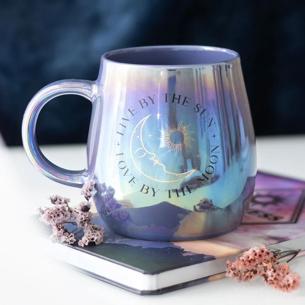 Iridescent mug with "Live by the Sun, Love by the Moon" design and celestial sun and moon motifs, 500ml capacity