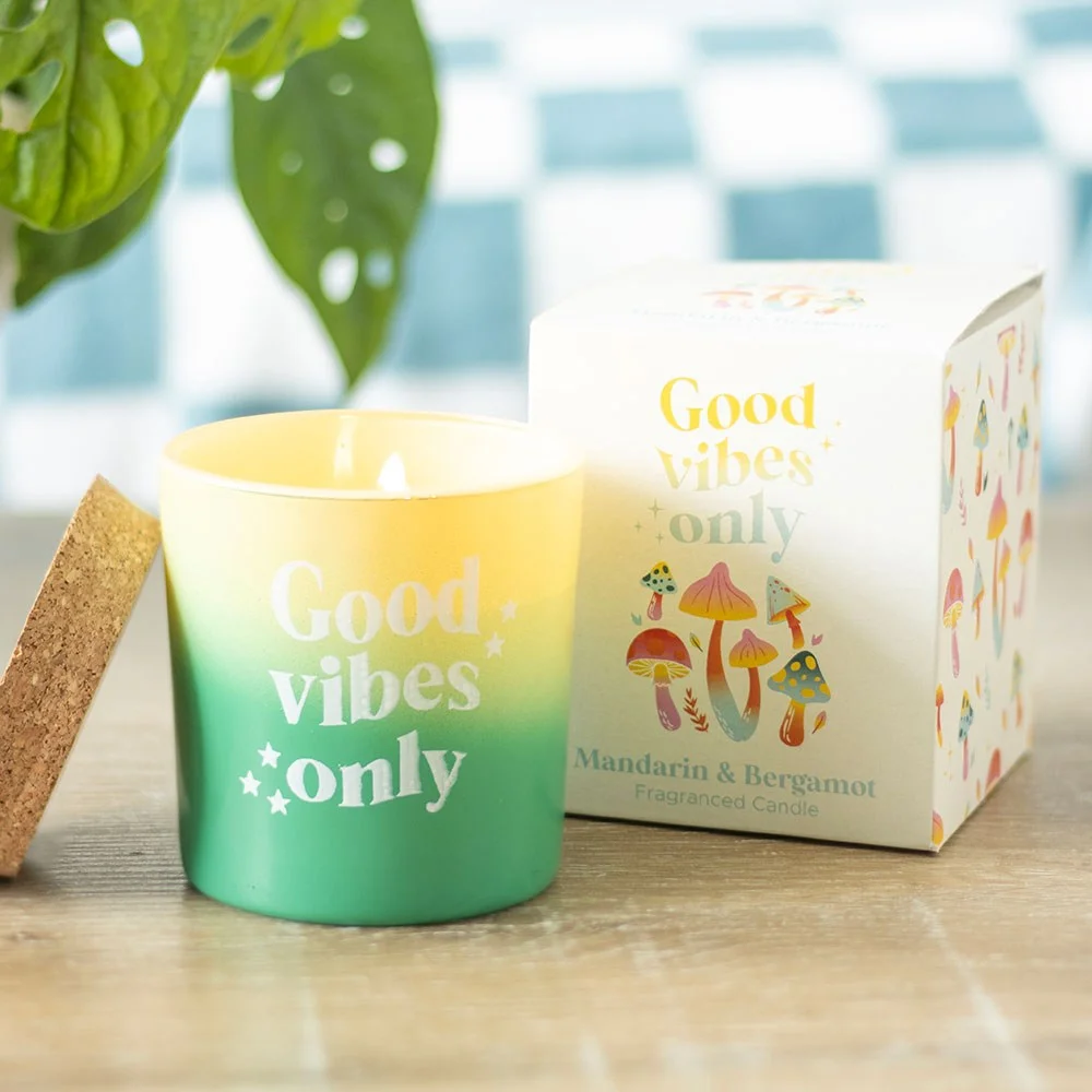 Mandarin bergamot candle in vibrant green glass pot with cork lid on white background