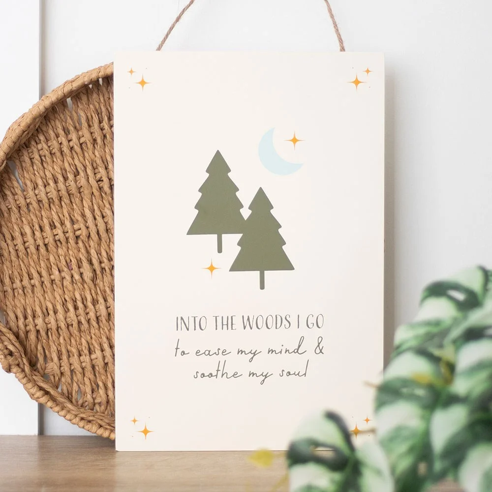 Wooden hanging sign with woodland scene and text "Into the woods we go to ease my mind & soothe my soul