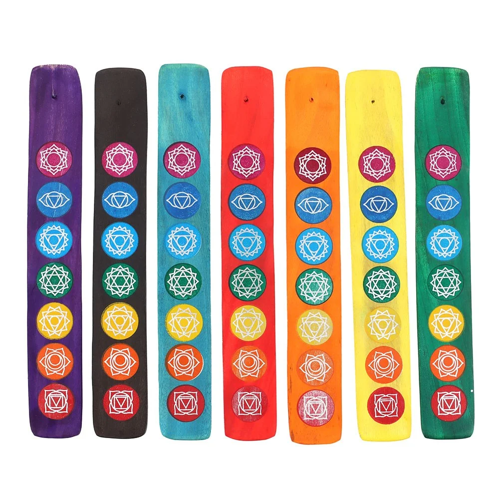 Set of 7 wooden chakra incense holders arranged in a row, each representing a different energy centre for meditation and yoga