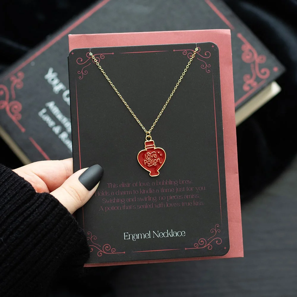 Love potion necklace with enamel charm displayed on a matching greeting card with envelope, nickel-free accessory
