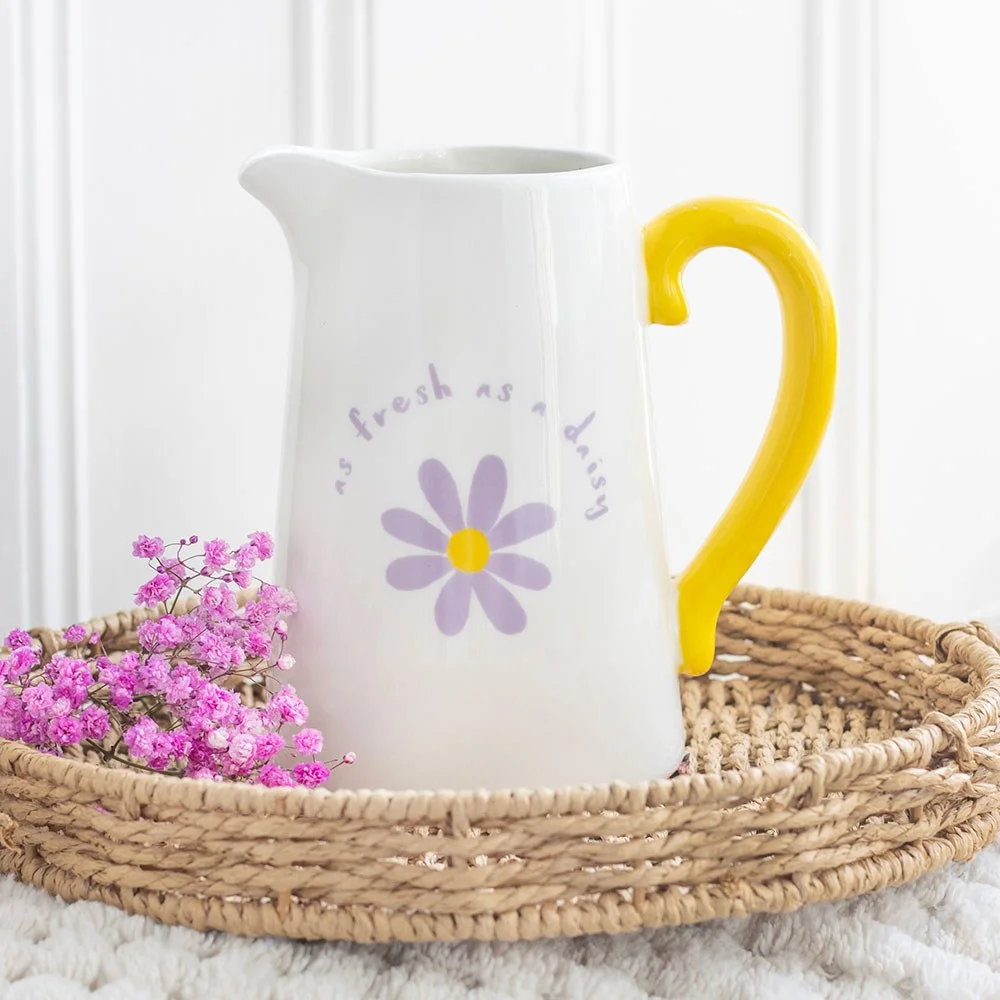 Purple and yellow ceramic flower jug with "As fresh as a daisy" design, 1100ml capacity on white background