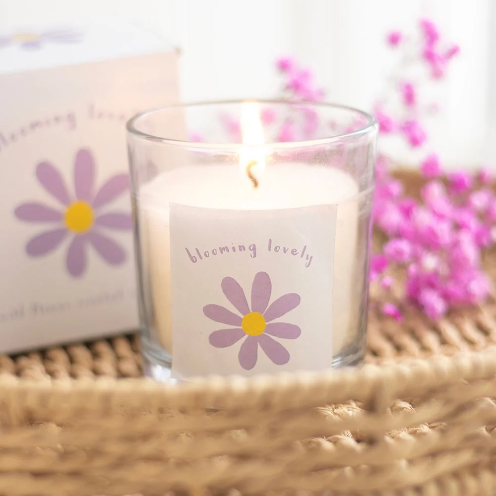 Purple and yellow daisy wildflower scented candle with Blooming Lovely text on white paraffin wax container