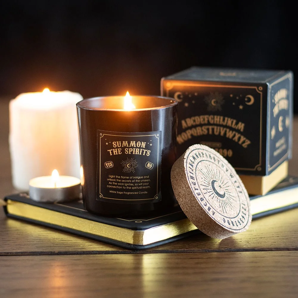 White sage candle with mystical spirit board design and cork lid on a white background
