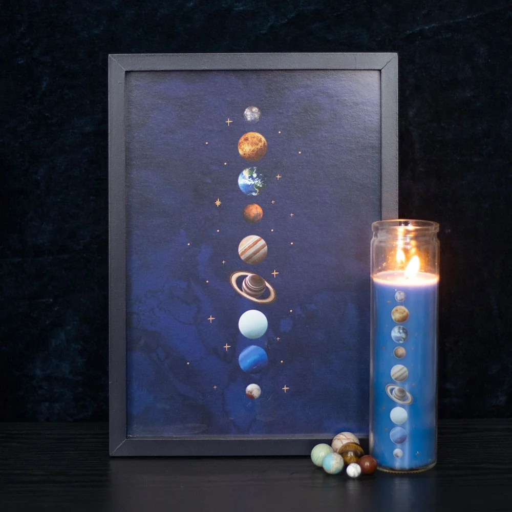 Framed solar system wall print with nine planets and gold stars on deep blue background in wooden frame