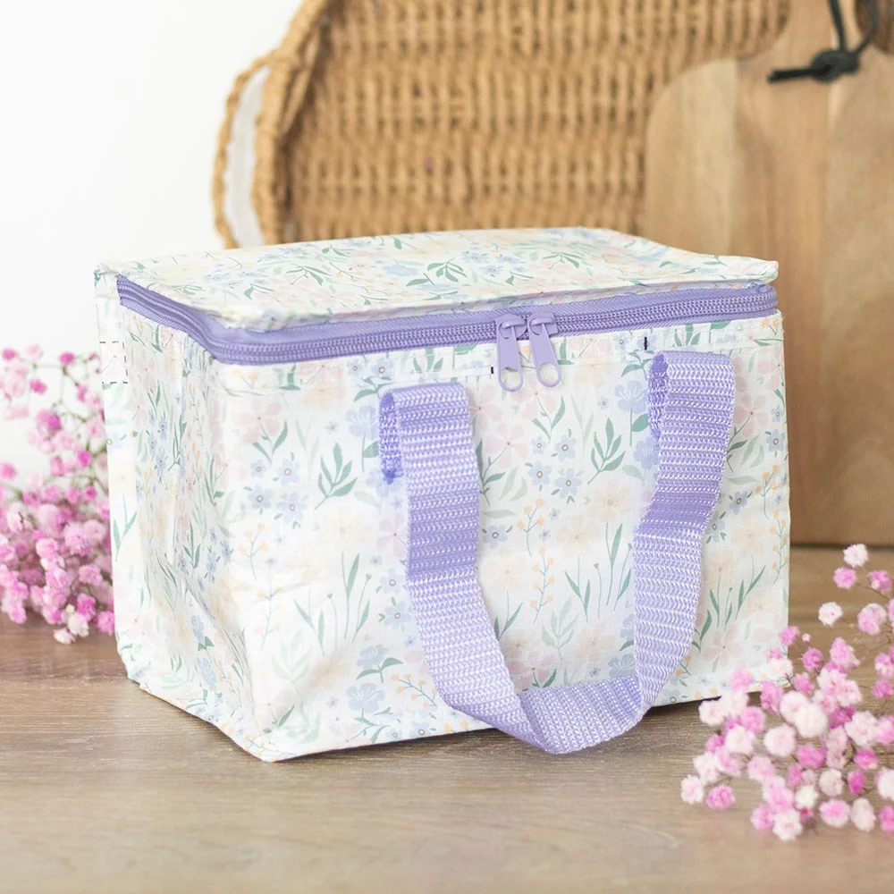 Insulated ditsy floral lunch bag with small spring flowers on a light background, made from recycled plastic, zip closure