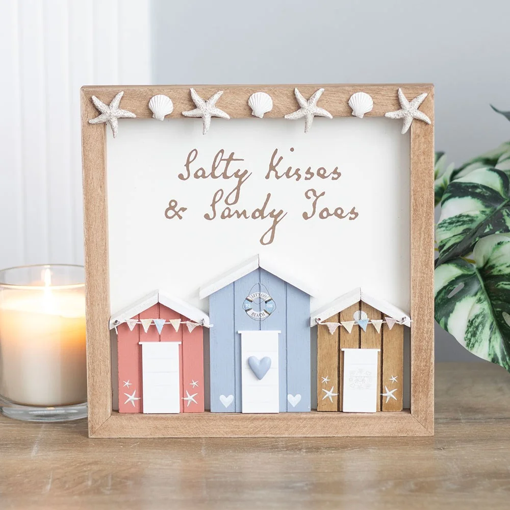 Pastel 3D beach hut wall plaque with text "Salty kisses & sandy toes" in decorative script on white background