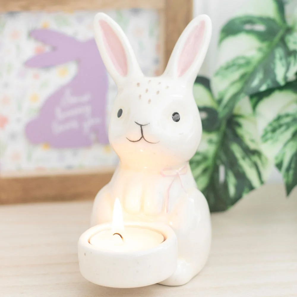 Ceramic bunny tealight holder shaped like an Easter bunny with a lit tealight inside, soft spring decor glow