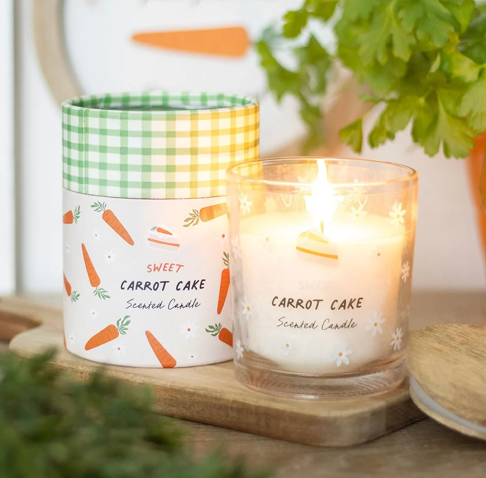 Glass carrot cake candle with sweet cake and carrot illustrations on packaging, ideal for spring and Easter gifts