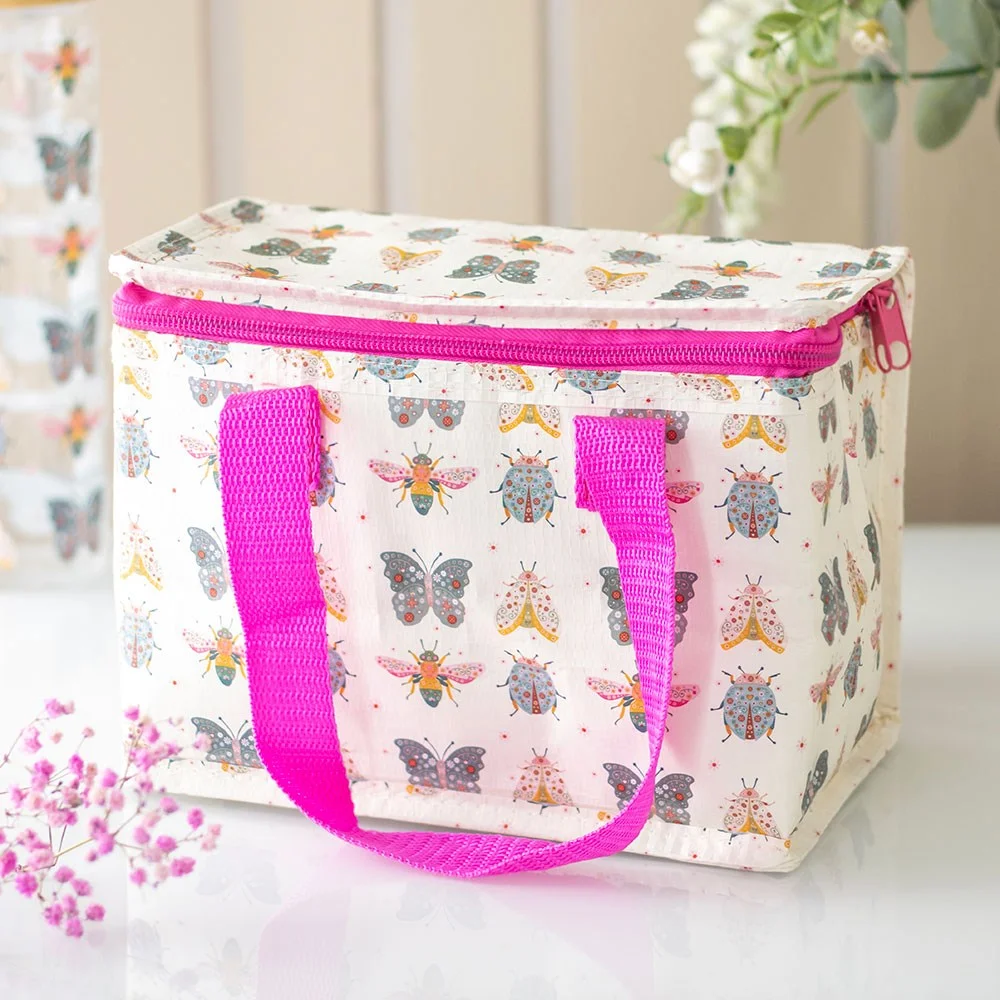Floral lunch bag with bright bug print, hot pink handles, insulated interior, made from recycled plastic, wipe clean