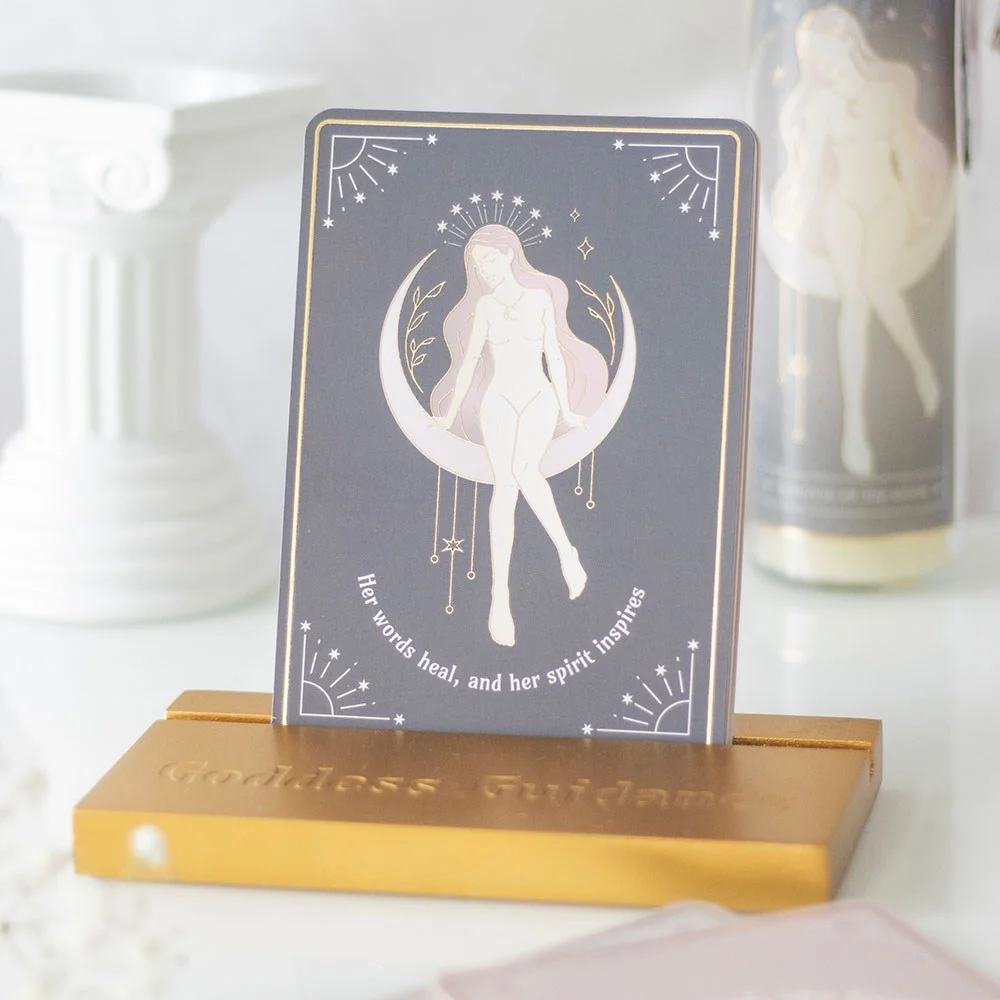 Set of 10 goddess affirmation cards with feminine illustrations displayed on a wooden stand for daily inspiration and self-love