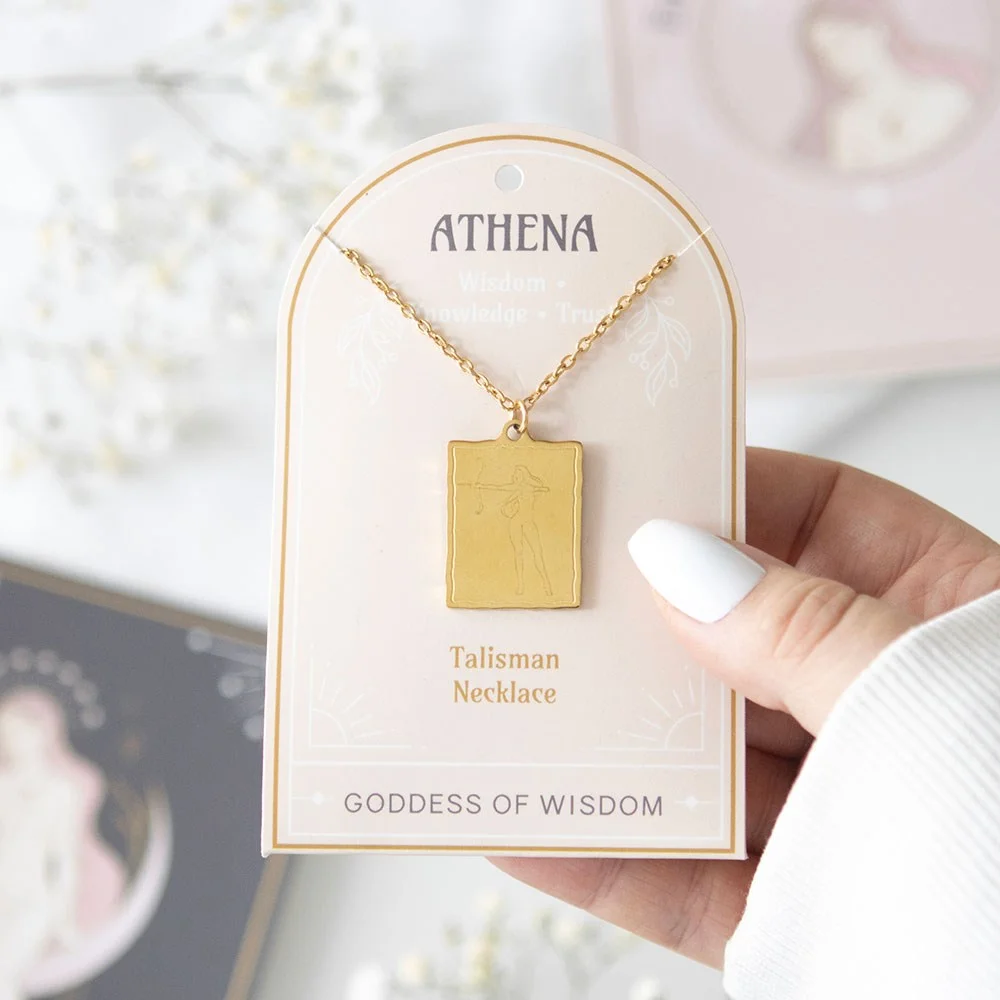 Gold-toned Athena goddess necklace with detailed pendant on a matching backing card, nickel-free stainless steel chain