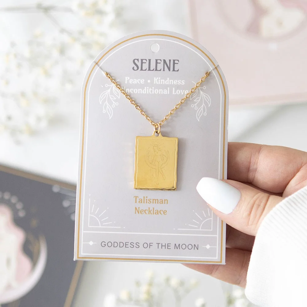 Gold-toned Selene goddess necklace with detailed pendant on a matching backing card, nickel-free stainless steel chain