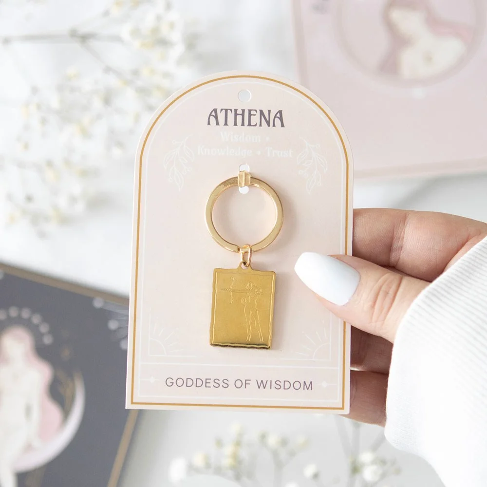 Gold-toned Athena goddess keyring with detailed pendant on a matching backing card for gifting or personal use