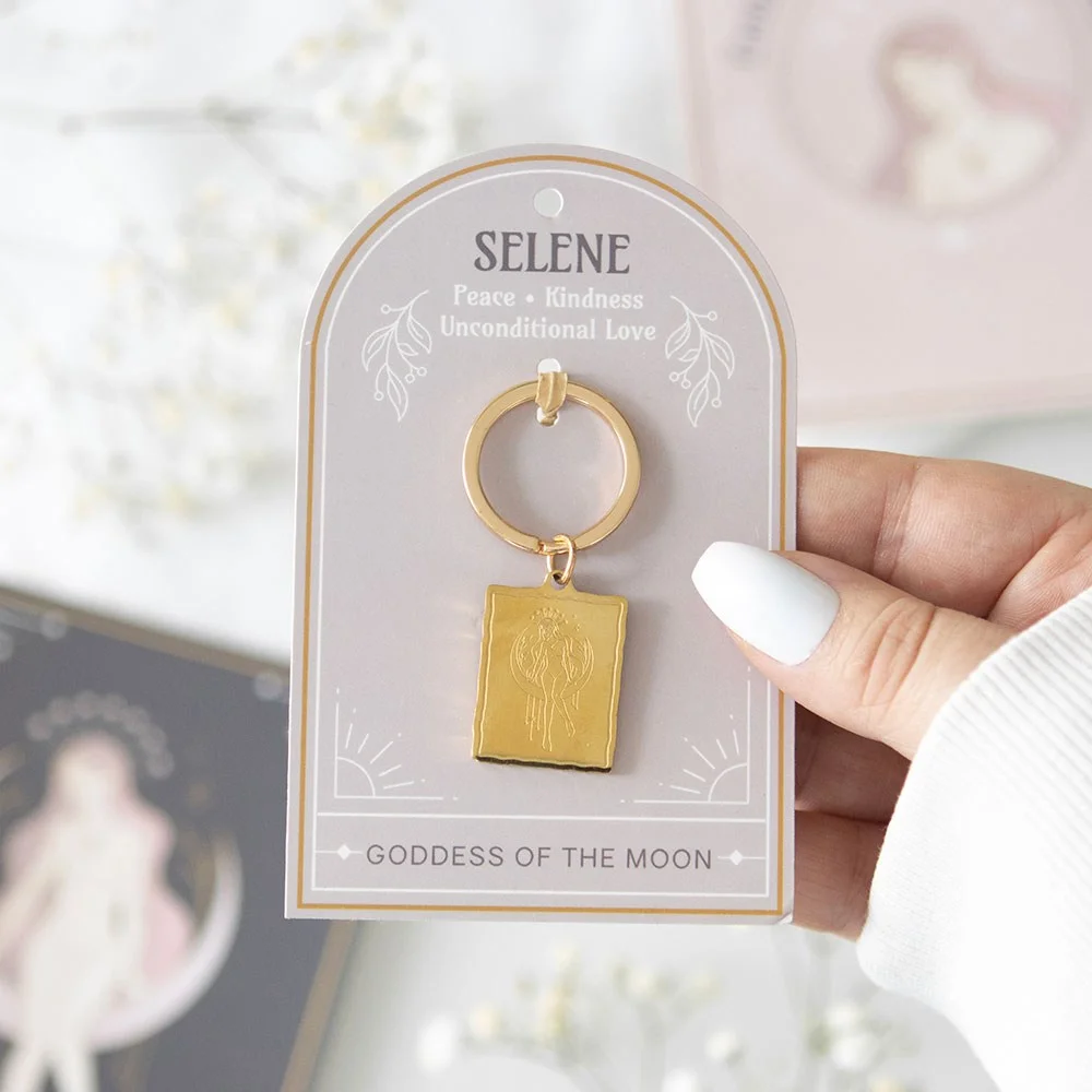 Gold-toned Selene goddess keyring with detailed pendant on a matching backing card for gifting or personal use
