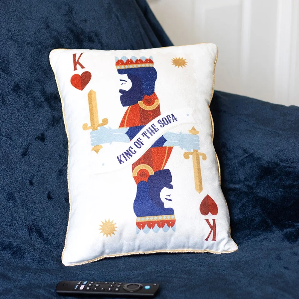 King of the Sofa playing card cushion with red, blue, and gold design and text on a white background