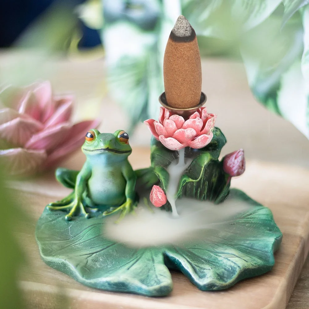 Frog on green lily pad backflow incense burner with smoke cascading down like mist over water surface