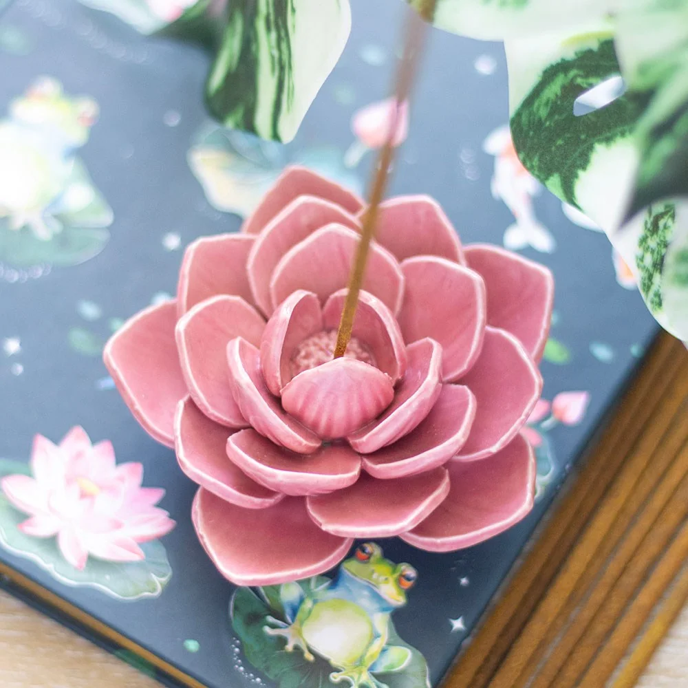 Delicate pink water lily incense holder with a single incense stick, designed for secure support and calm ambiance