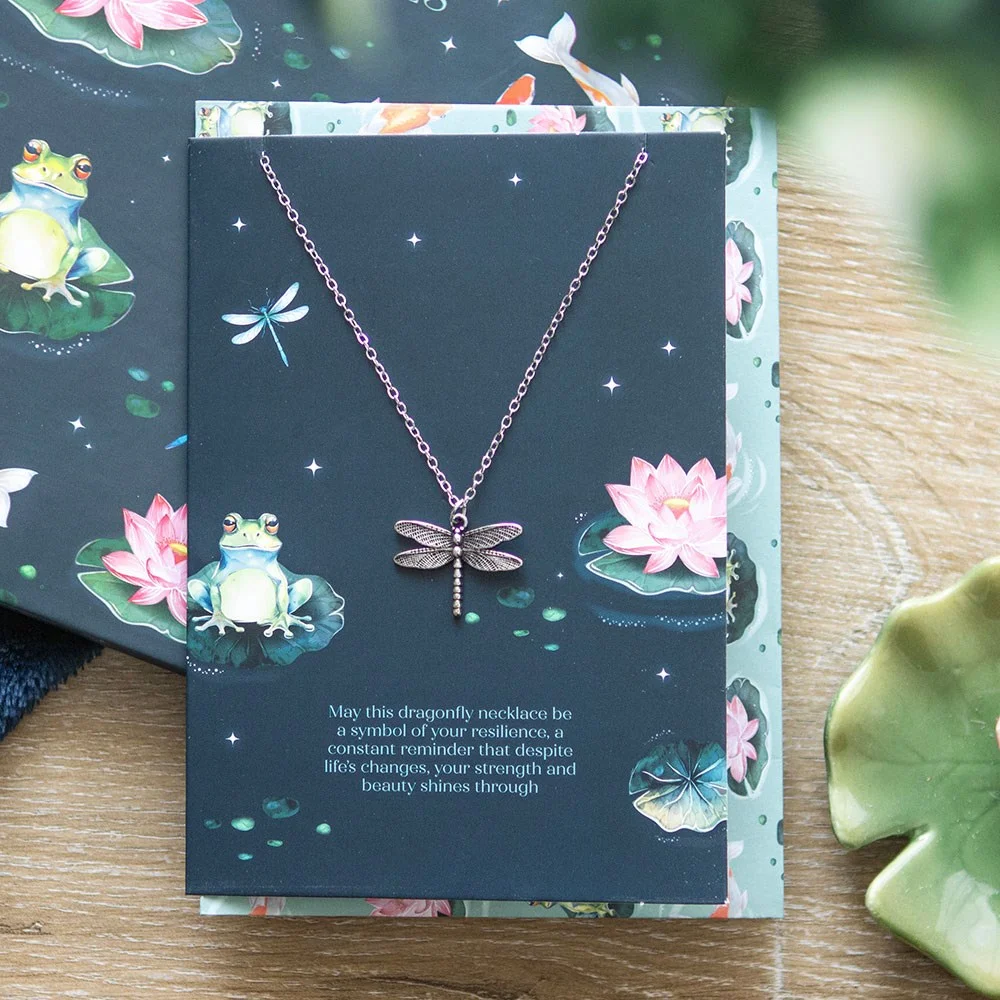 Silver-tone dragonfly necklace on a dainty chain displayed on a greeting card with pond-themed frogs and lily pads, dragonfly necklace gift