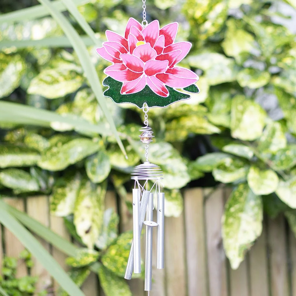 Pink water lily windchime with resin flower and metal chimes hanging against a blurred garden background