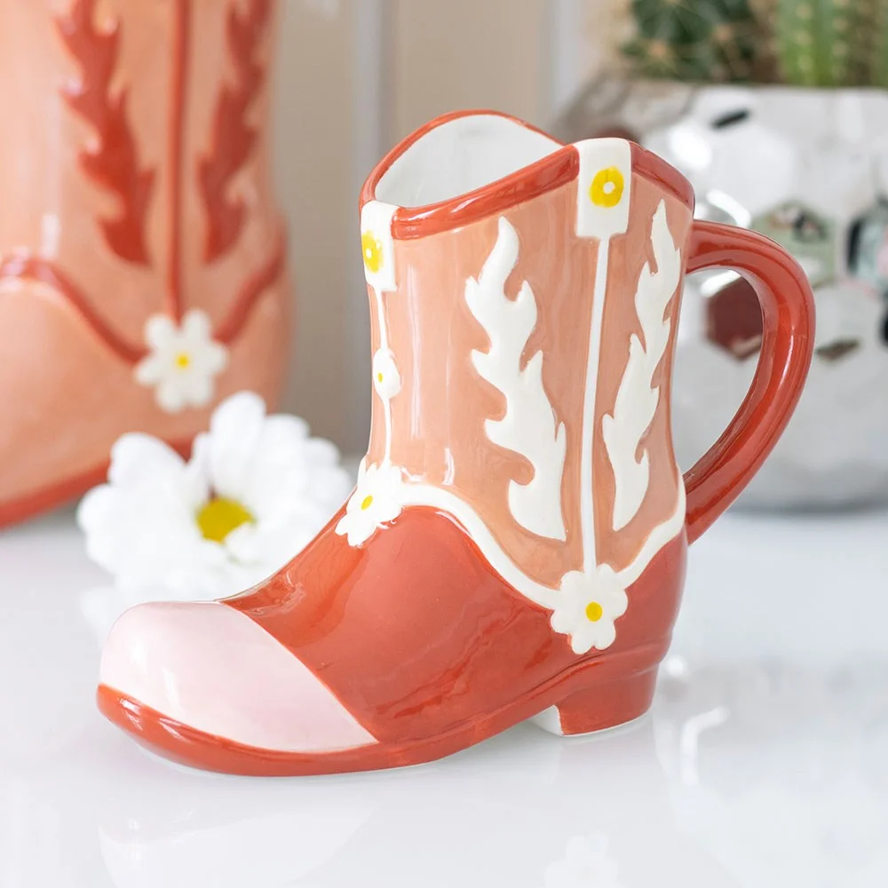 Pink cowboy boot mug with detailed stitching and heel, designed for cold drinks, hand wash only accessory
