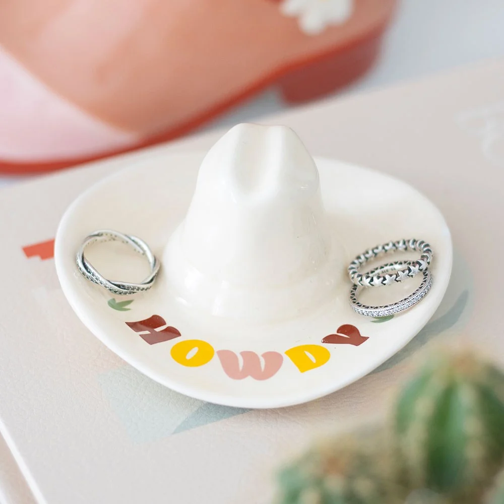 Cowboy hat trinket dish with 'Howdy' on brim, shaped like a brown cowboy hat for holding jewellery and small treasures
