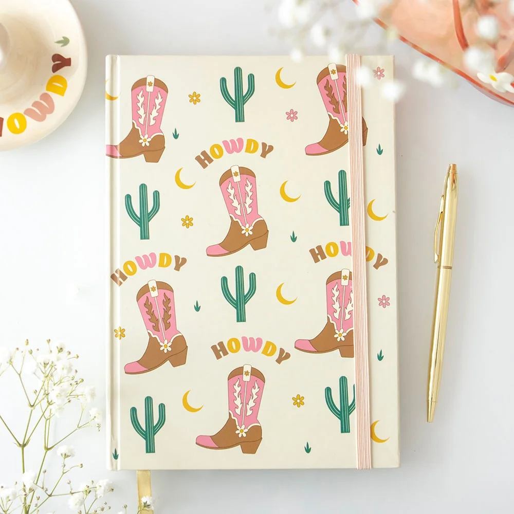 Cowboy boot notebook with girly Western design, 'Howdy' text, and matching sticker sheet featuring boots and cacti