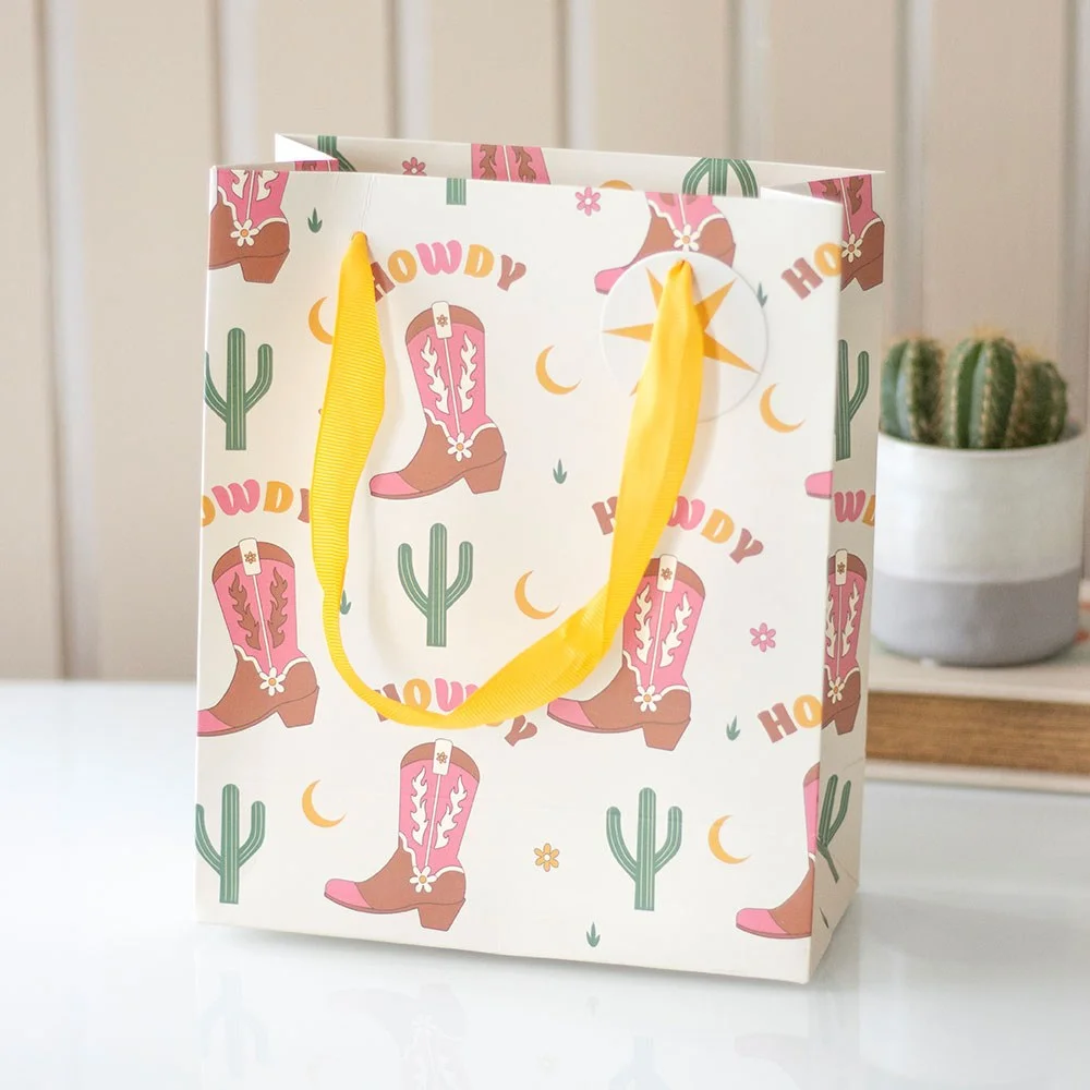 23cm cowboy boot gift bag with retro rodeo print, girly Western design, and Howdy text on a white background