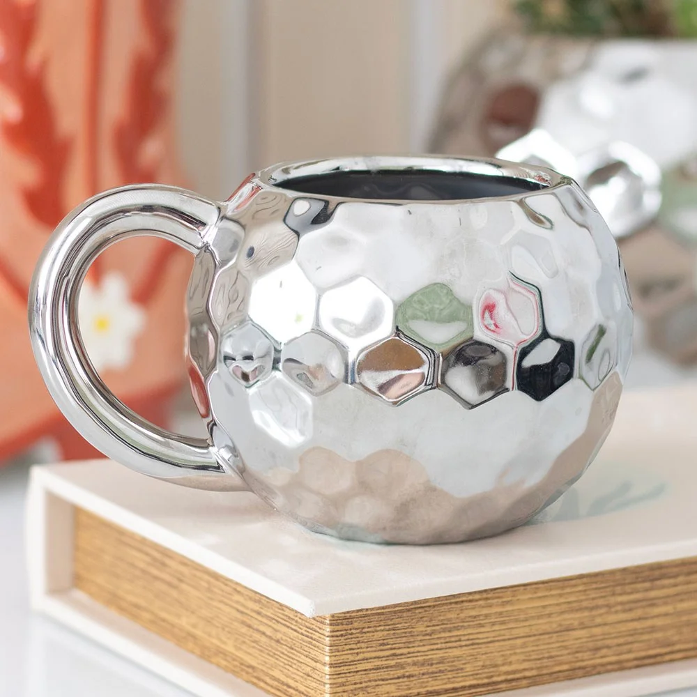 Silver disco ball mug with reflective ceramic surface and handle, 400ml capacity, on white background