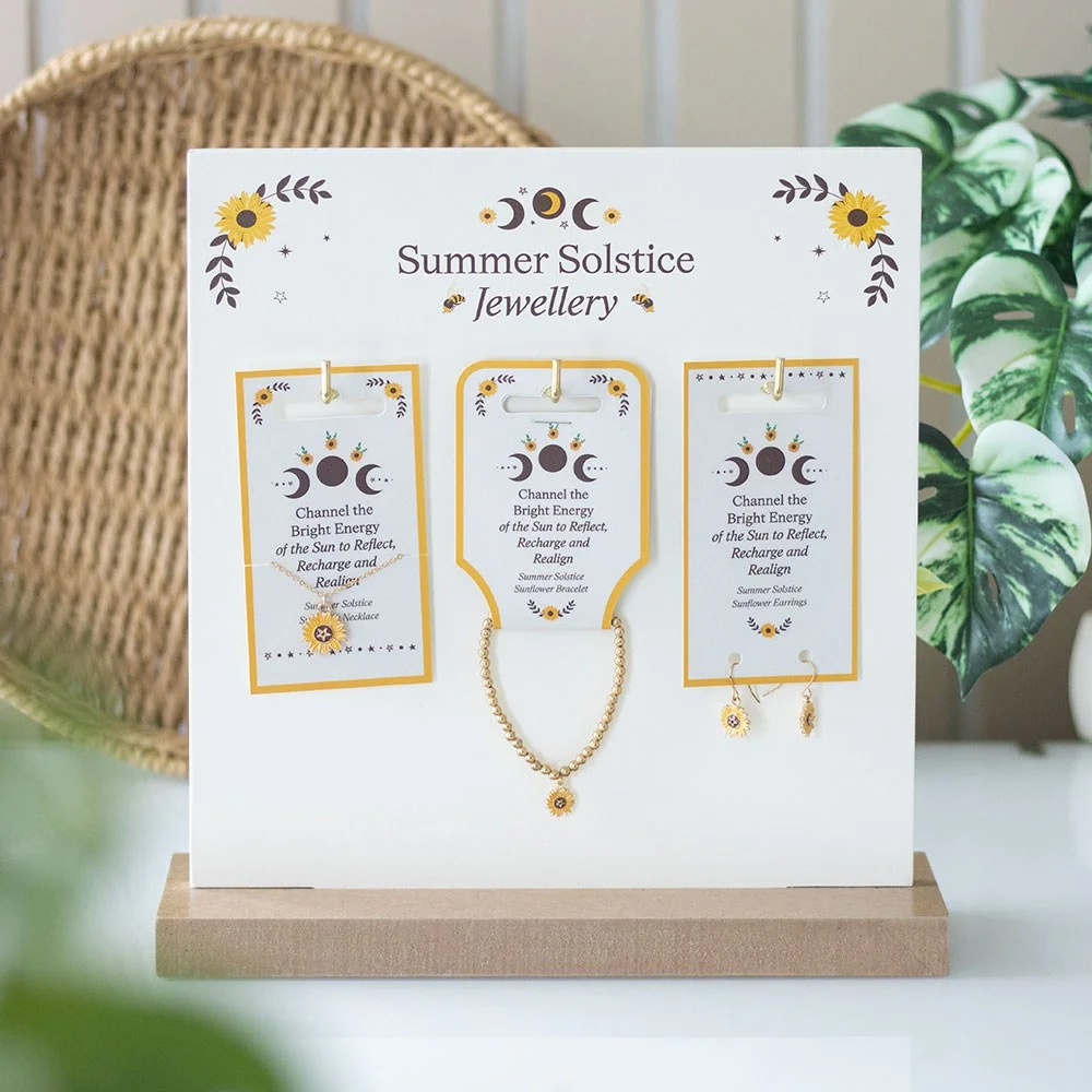Set of 18 summer solstice jewellery set pieces with sunflower charms displayed on matching MDF countertop stand