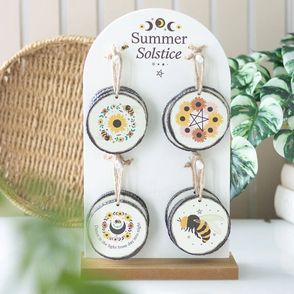 Set of 16 summer solstice decorations featuring sunflowers, bees, pentagrams, and moon phases on a wooden display stand