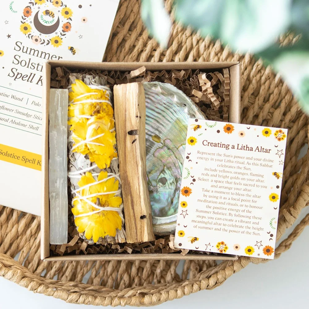 Summer Solstice spell kit with sunflower sage smudge stick, Palo Santo, selenite wand, abalone shell, and info card in gift box